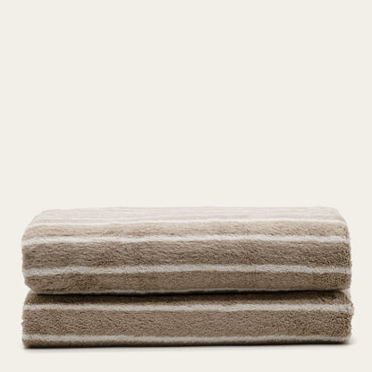 Striped cotton bath towels, folded stack with horizontal stripes in taupe and white