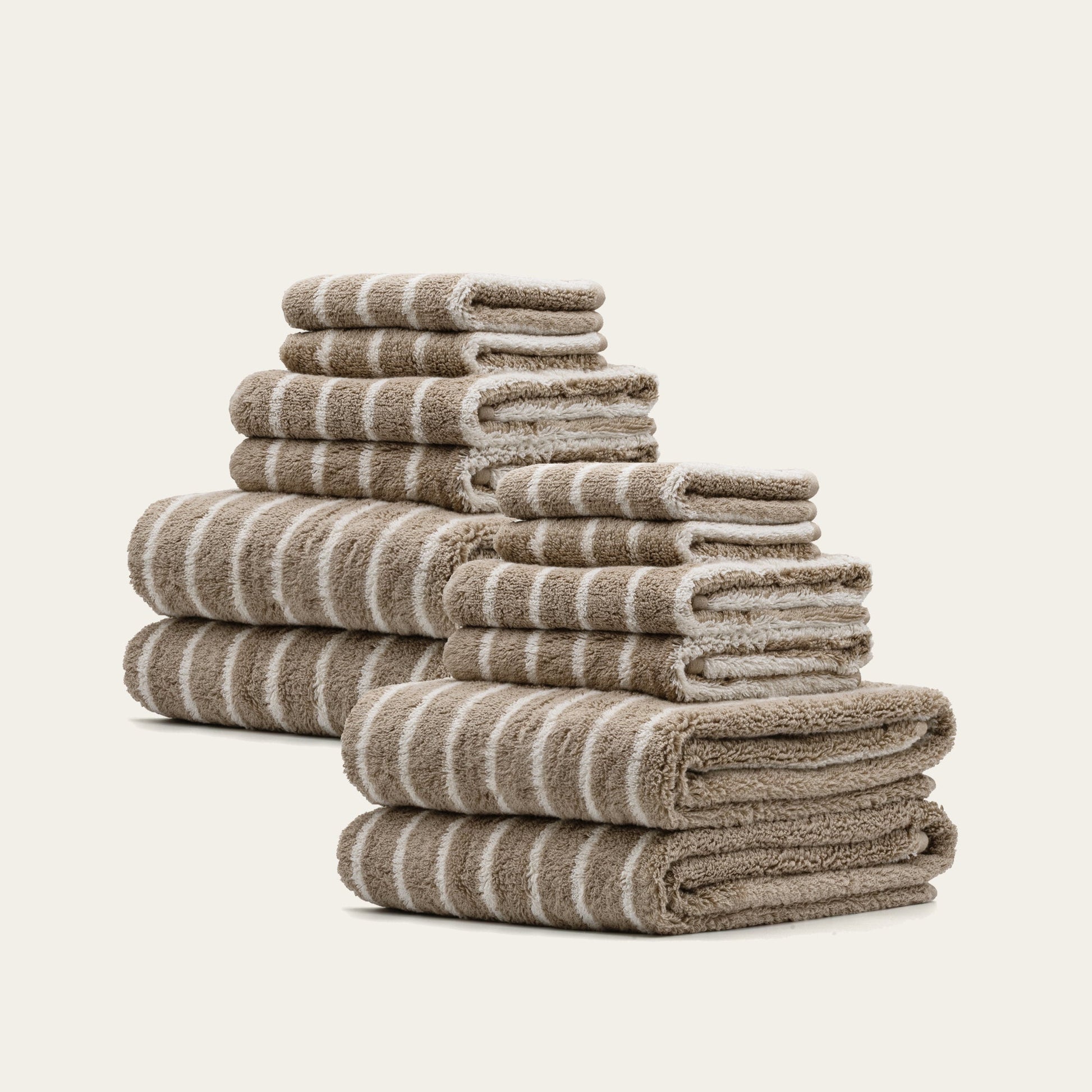 Stacked striped towels, beige and white plush cotton loops