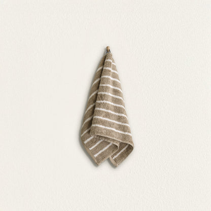 Striped cotton hand towel hanging, taupe with wide white stripes and terry border