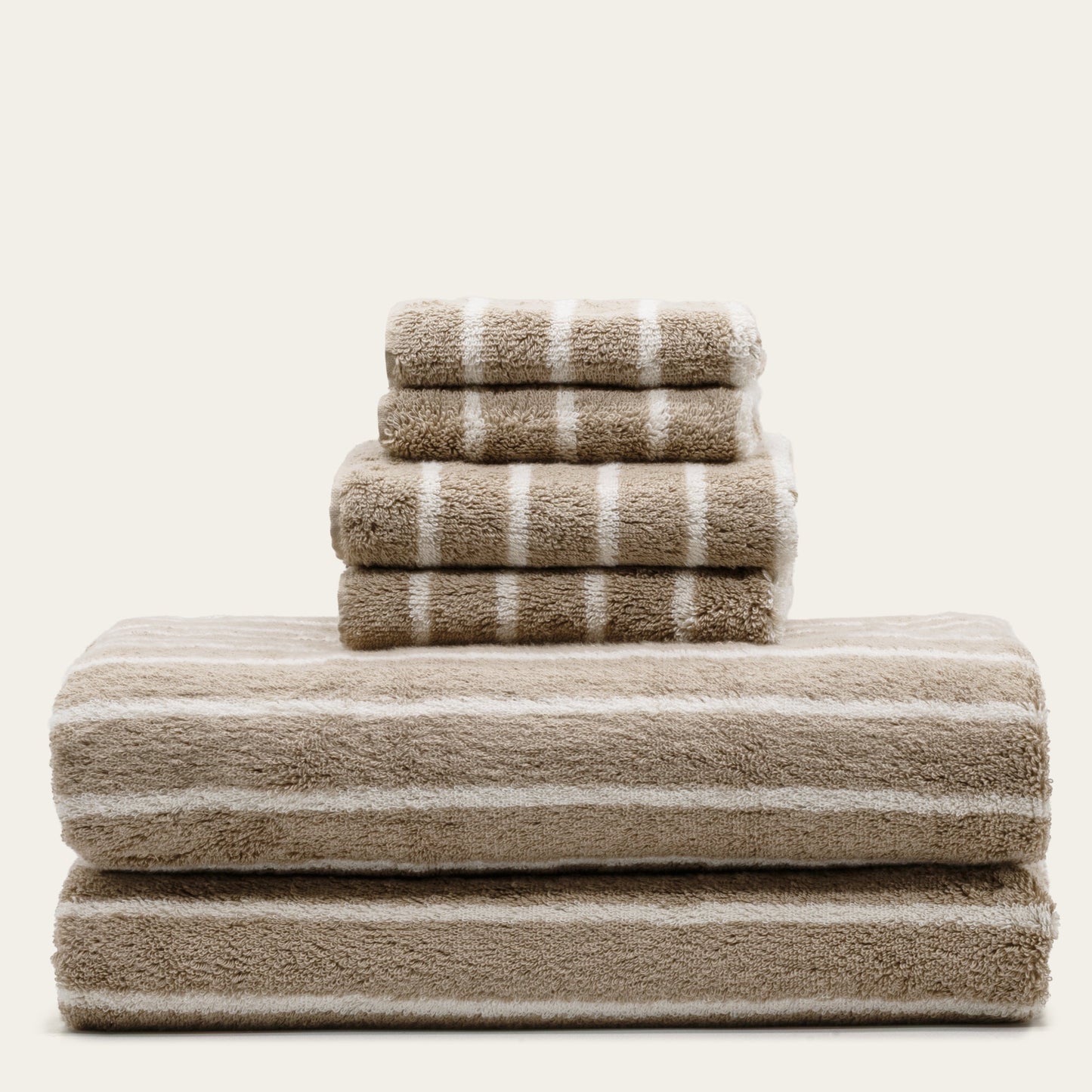 Striped hand towels stack, beige and white plush cotton loops