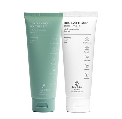Two toothpaste tubes side by side: Gentle Green™ mint and Brilliant Black™ whitening