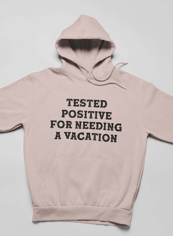 Mauve hoodie with front text 'TESTED POSITIVE FOR NEEDING A VACATION'