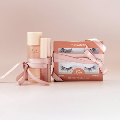 Lash routine set with pink gift boxes and bottles, tied ribbon packaging