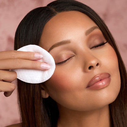 Lash routine set application: model gently dabs eye area with white cotton pad