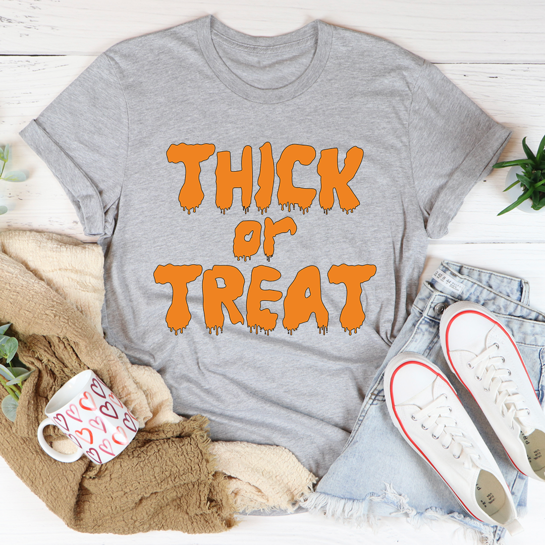 Light grey graphic T-shirt with orange “Thick or Treat” dripping print