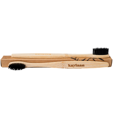 Bamboo toothbrush set in cardboard box with black bristles