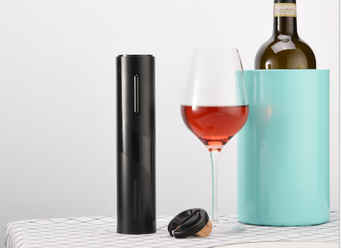 Black electric wine opener with clear corkscrew chamber on a table
