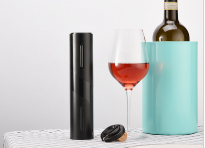 Black electric wine opener with clear corkscrew chamber on a table