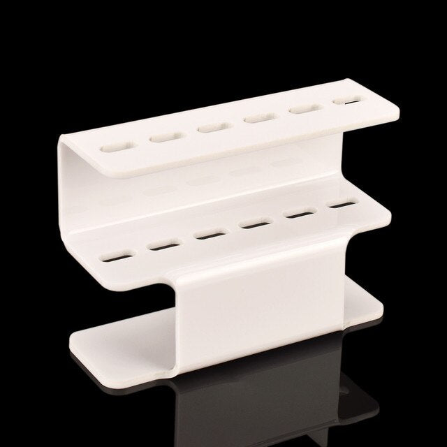 White acrylic eyelash tweezer holder with two shelves and row of slot holes