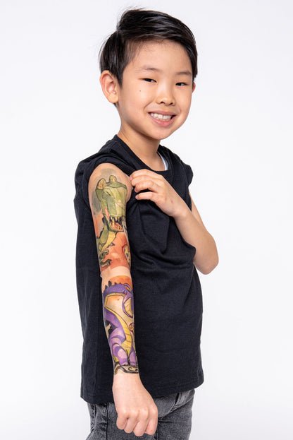 Kids temporary dinosaur tattoo sleeve, green and purple dinos on forearm