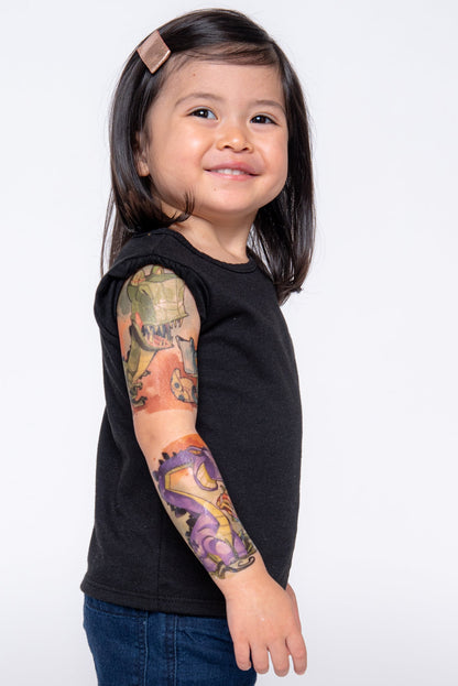 Kids temporary dinosaur tattoo sleeve, green and purple dinos on upper arm