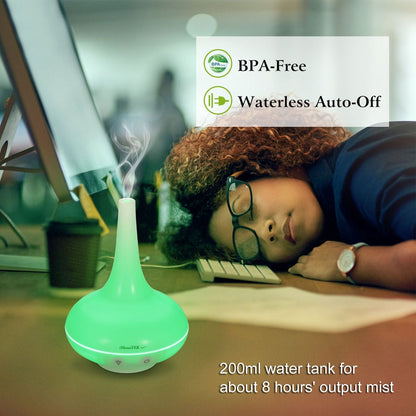 Green ultrasonic cool mist humidifier and aroma diffuser on desk with BPA-free label