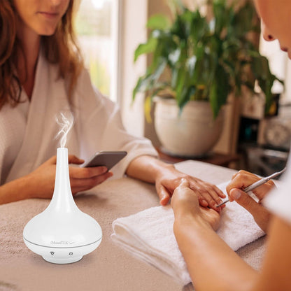 White ultrasonic cool mist humidifier aroma diffuser on table with mist control