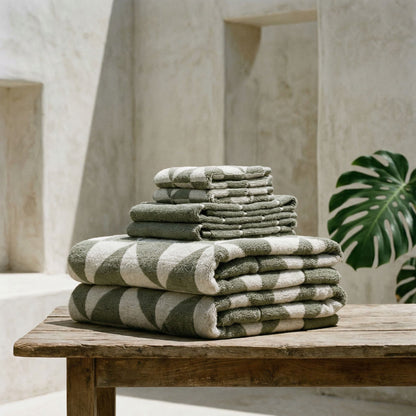 Cotton beach towel stack on a ledge, gray-green and white geometric triangle pattern
