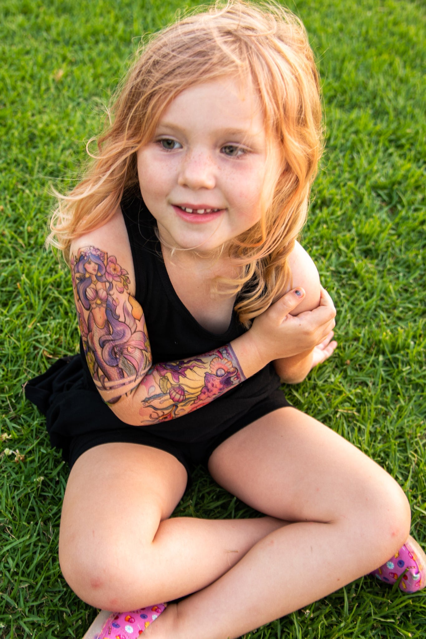 Temporary kids under-the-sea tattoo sleeve on child’s arm with purple sea-creature design
