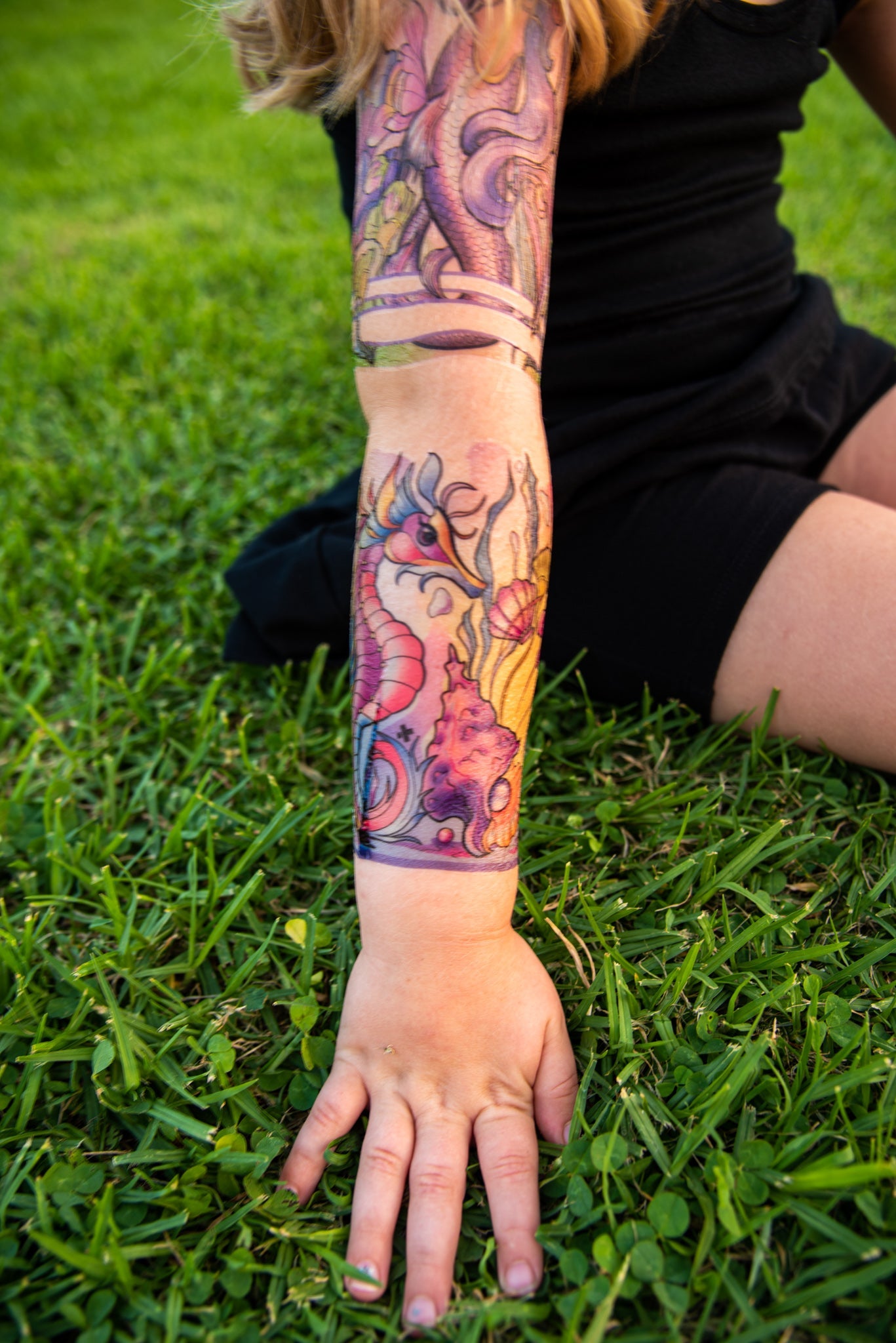 Temporary kids under-the-sea tattoo sleeve on arm with seahorses and coral details