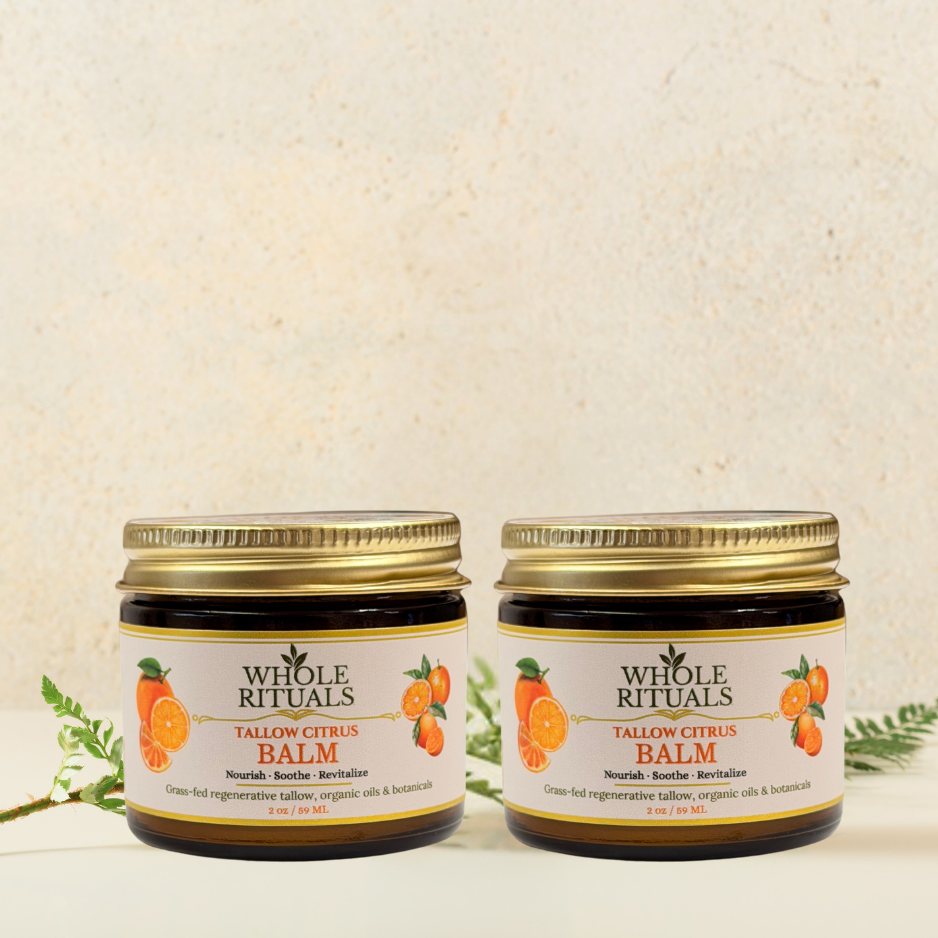 Two tallow citrus balm jars with gold lids, Whole Rituals citrus labels, front view