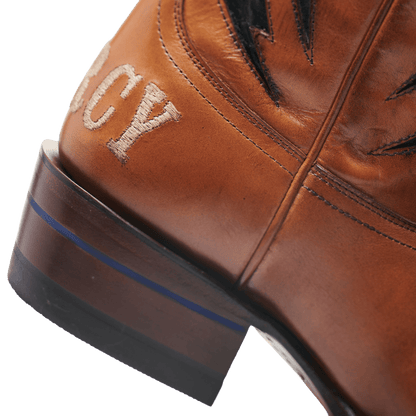 Brown cowboy boot with blue-trimmed sole edge and star-and-lightning stitching