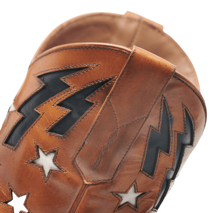 Brown cowboy boot toe with black lightning embroidery and star accents