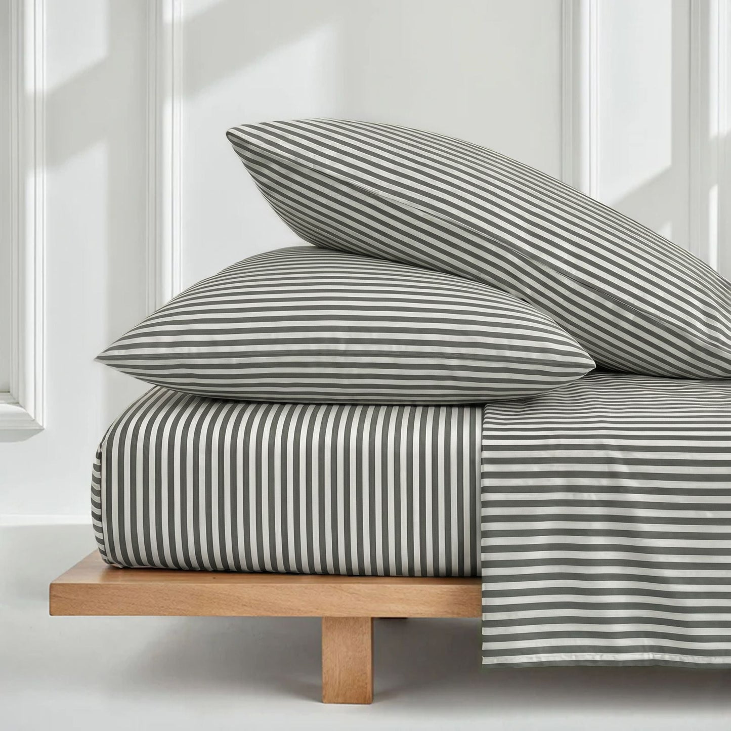 Striped bedding set with folded duvet and two matching pillow shams