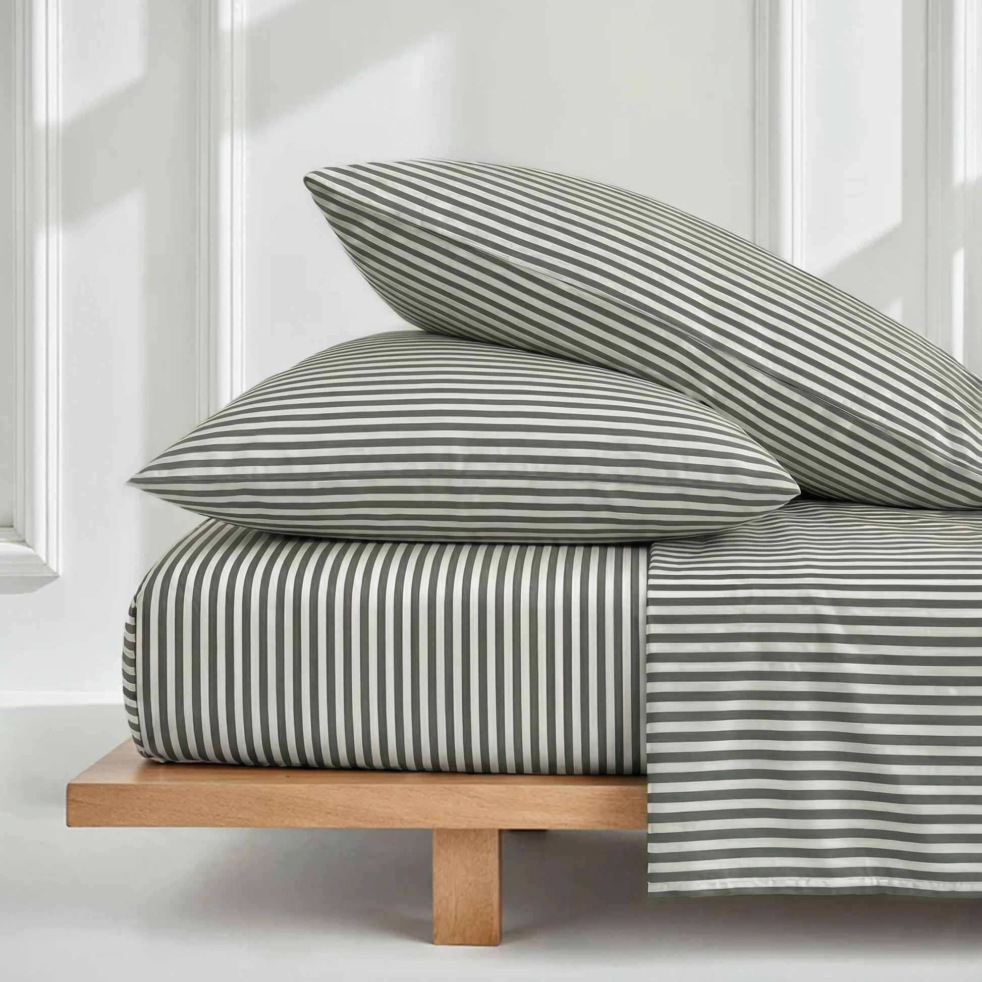 Striped bedding set with folded duvet and two matching pillow shams