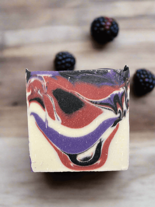 Vegan soap bar, rectangular with marbled purple, red, and cream swirl pattern