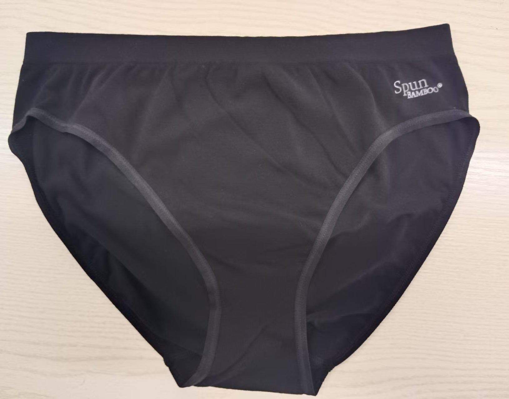 Women's high-leg brief underwear in black, folded flat