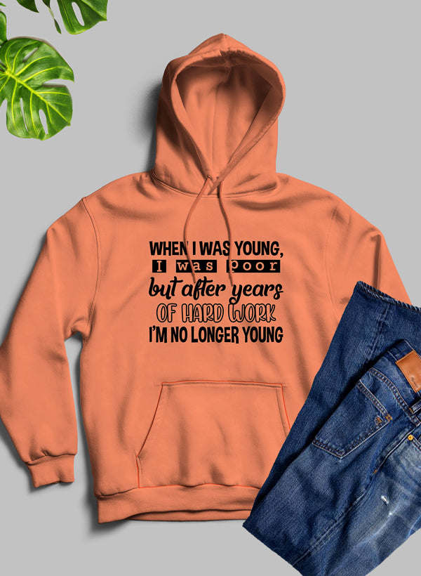 Orange hoodie with hood, front pocket, and printed slogan on chest