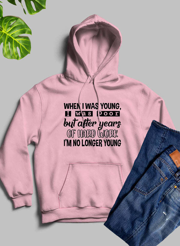 Pink hoodie with hood, front pocket, and printed slogan on chest