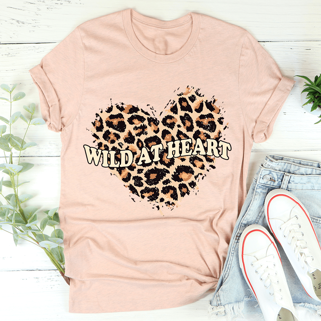 Soft pink crew-neck T-shirt with leopard heart graphic and "Wild At Heart" text