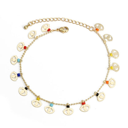Gold charm bracelet with coin-style charms and red, blue, and turquoise bead accents