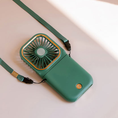 Mini cooling foldable fan in green with shoulder strap and square front grille