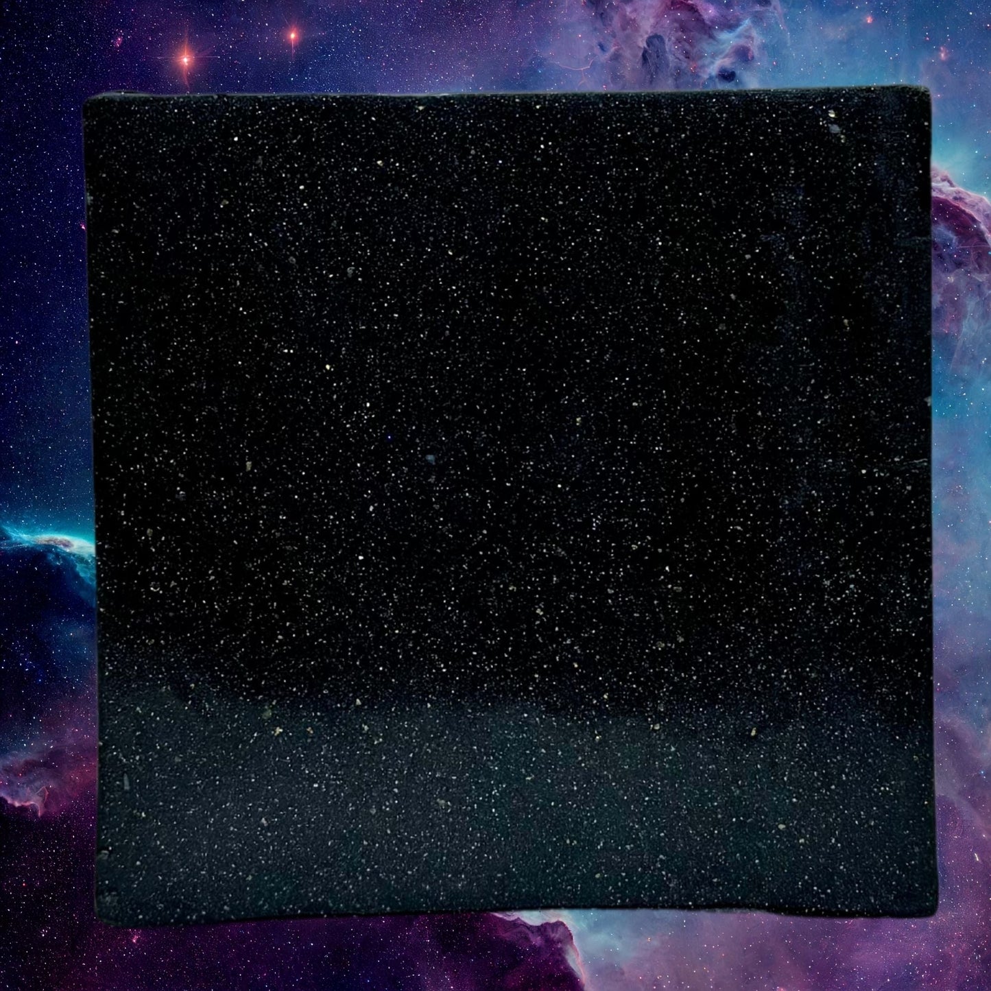Zero Gravity soap bar, dark blue speckled square face, flat top view