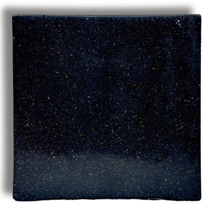 Zero Gravity soap bar, close-up dark blue speckled square surface