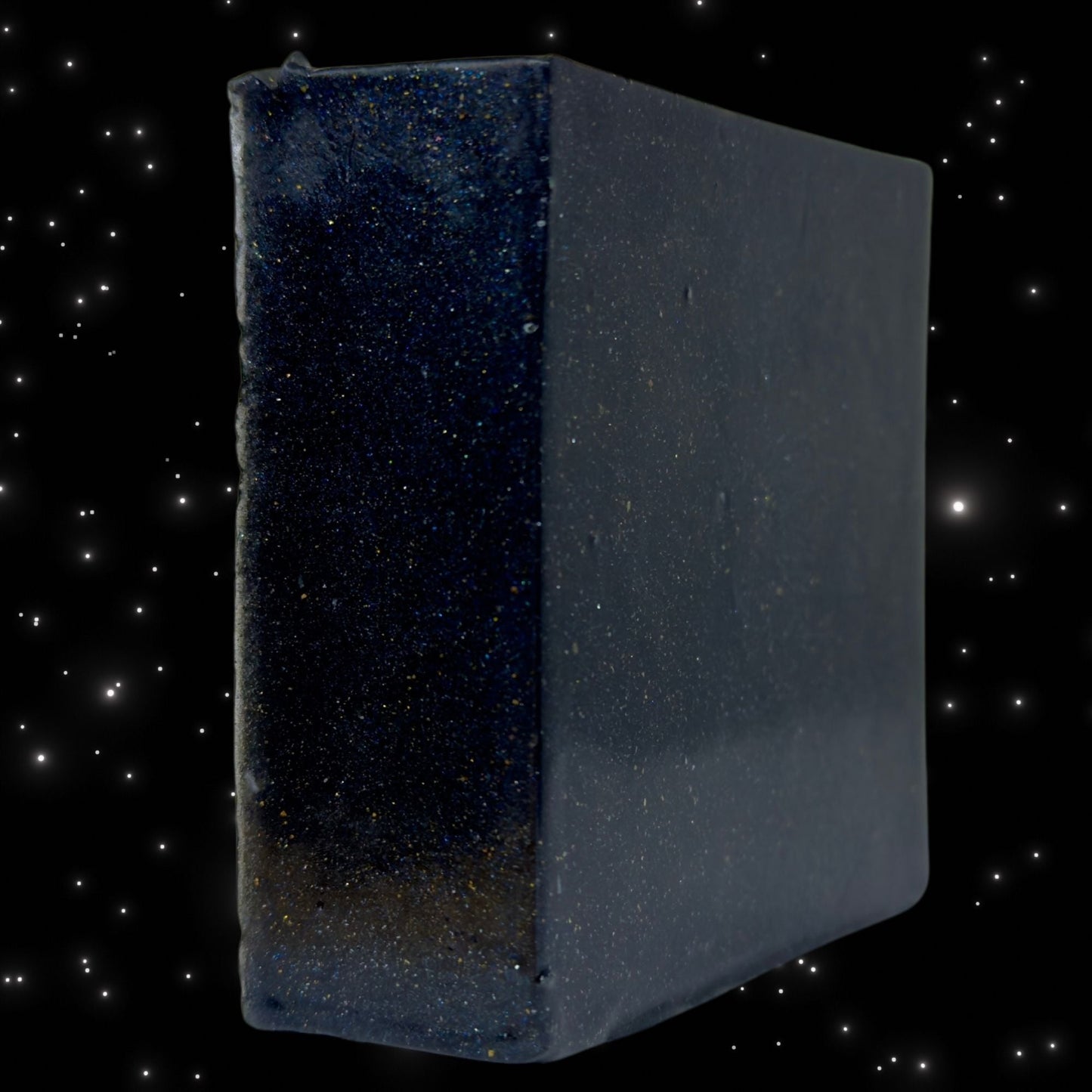 Zero Gravity soap cube, dark blue speckled cube with rounded edges, side view
