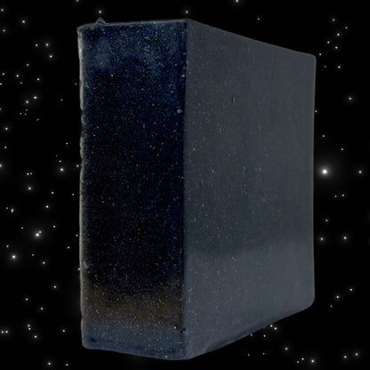 Zero Gravity soap cube, dark blue speckled cube with rounded edges, side view