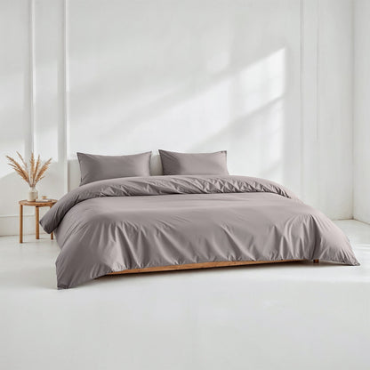 Gray sateen bedding bundle with duvet and two matching pillows on a bed