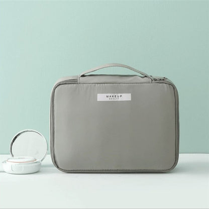 Gray cosmetic bag with top handle and side strap pocket