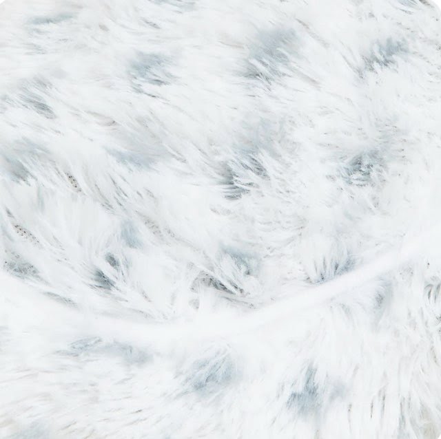 White plush fabric close-up with light blue dotted pattern