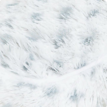 White plush fabric close-up with light blue dotted pattern