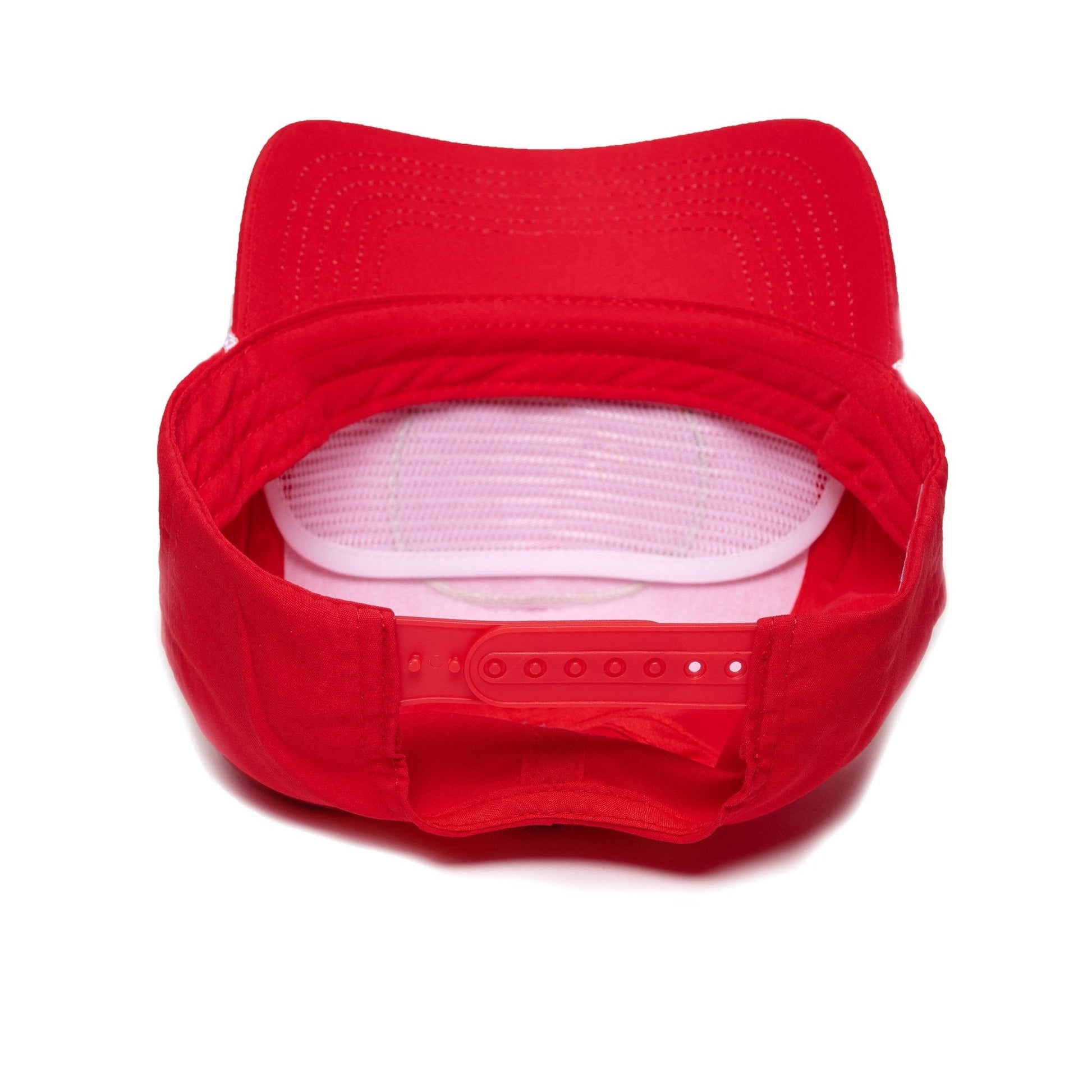 Red snapback hat, interior mesh visible with adjustable buttoned strap.