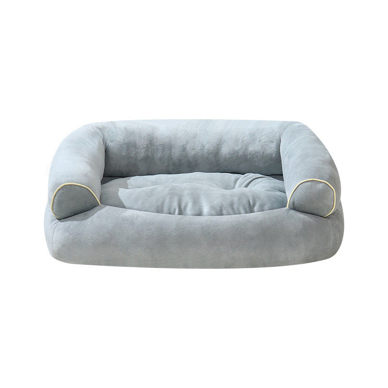 Light gray fabric pet sofa bed with rounded bolsters and beige piping trim.