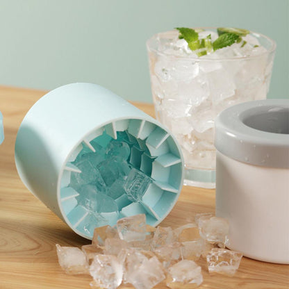 Light blue silicone cylinder ice maker bucket with ice cubes inside open tray