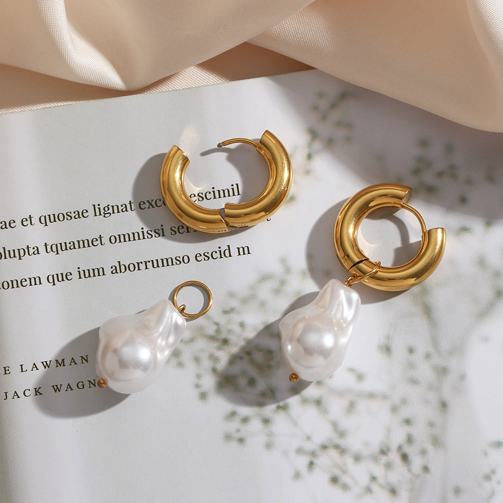 Gold-tone hoop water-drop earrings with white synthetic pearl drops, angled pair