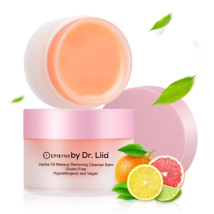 Pink makeup remover balm jar with orange balm top and citrus garnish