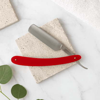 Red handle razor with silver head and curved guard.