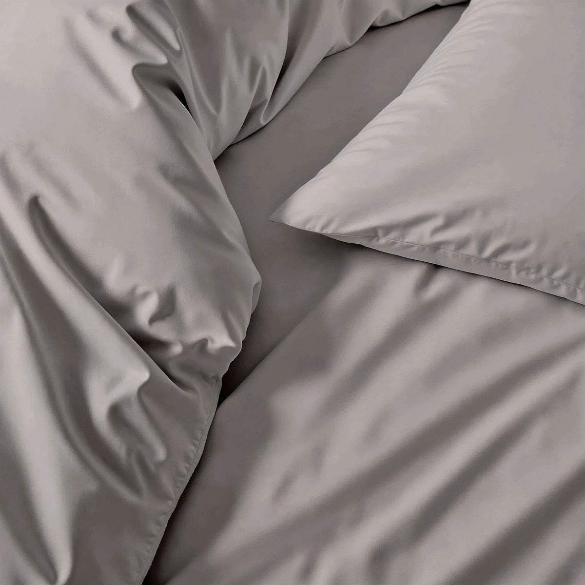 Luxe sateen pillowcase set, gray close-up of smooth fabric and pillow seam
