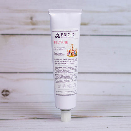 Hand lotion tube with flip-top cap, white tube labeled BRIGID BELTANE