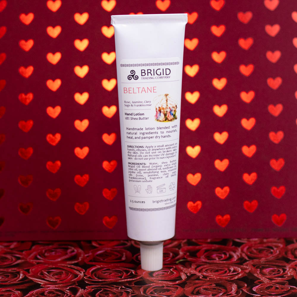 Hand lotion tube standing upright, white tube labeled BRIGID BELTANE