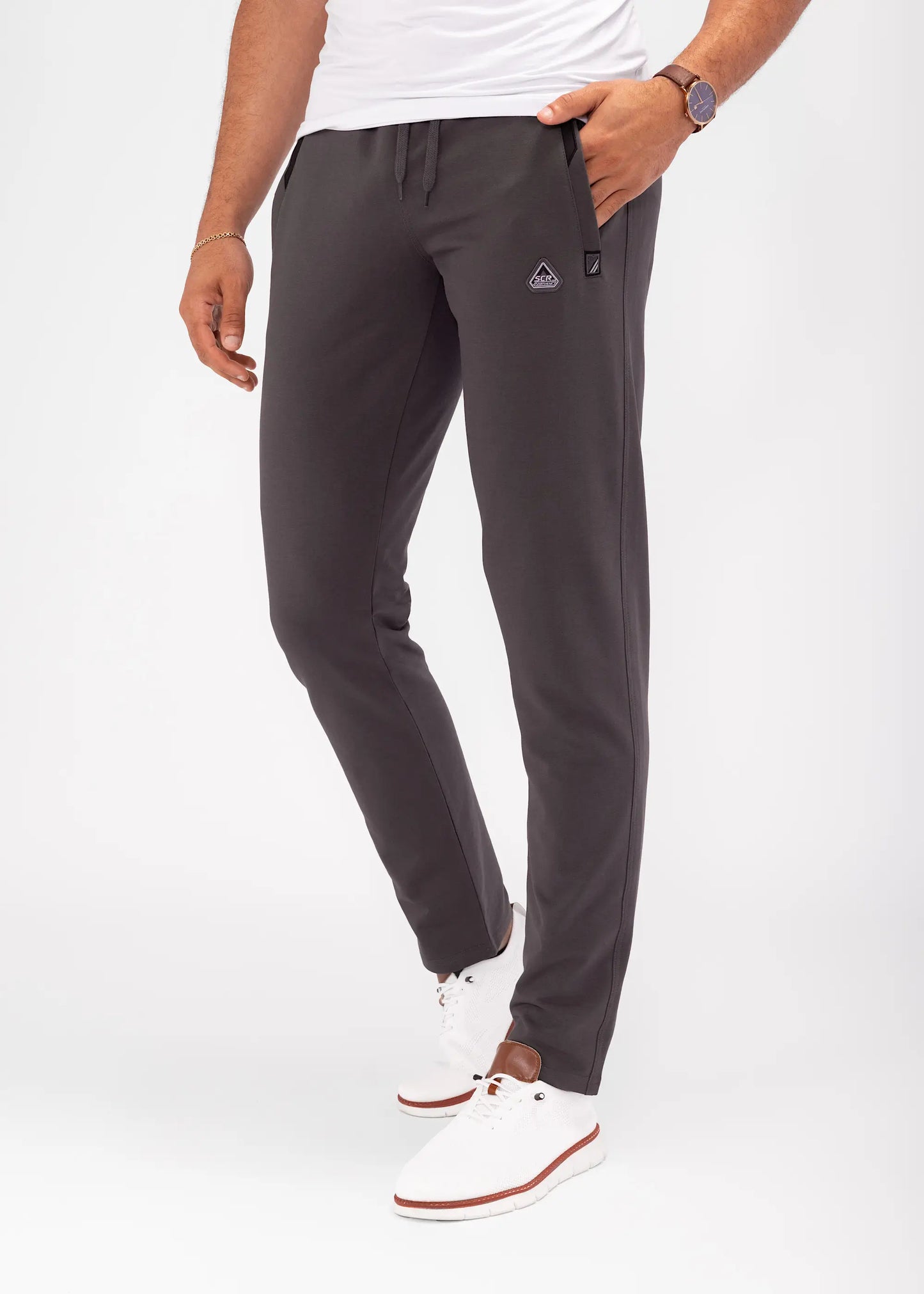Athletic sweatpants with tapered legs, elastic waistband, and drawstring; dark grey.